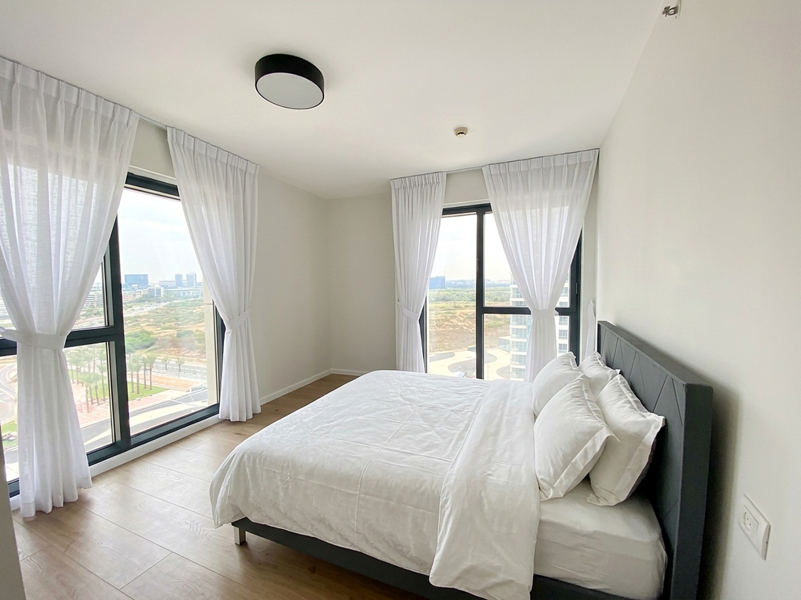 Master bedroom with floor-to-ceiling windows and coastal light