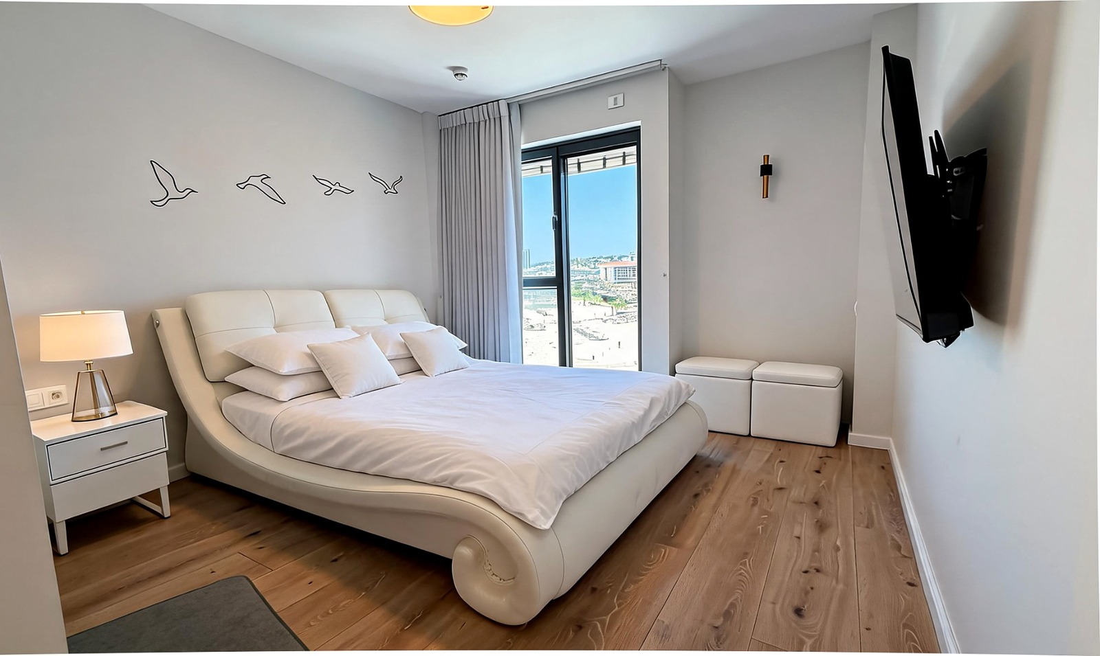 Second bedroom with sea-facing window and contemporary furnishings